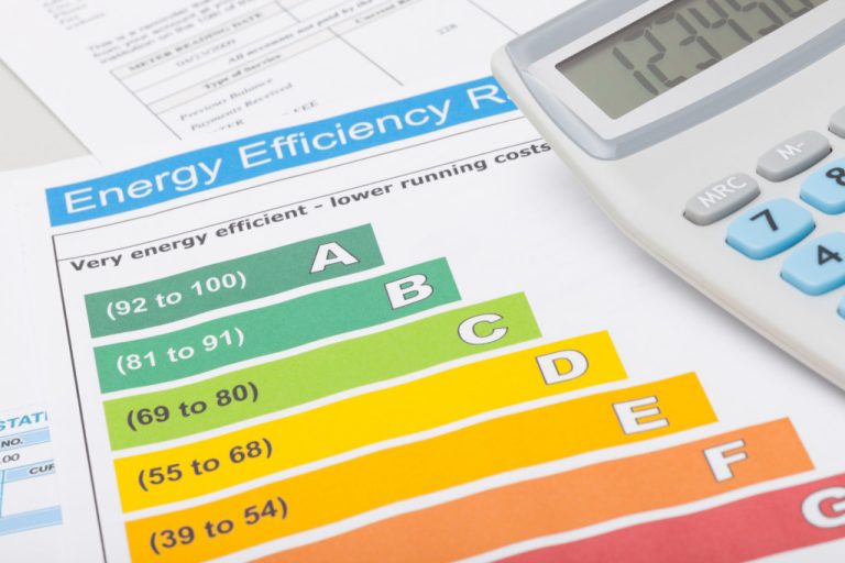 energy efficiency report documents with calculator on the side