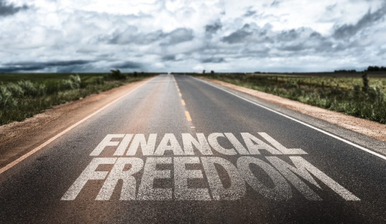 financial freedom written on rural road