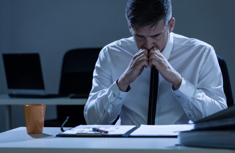 businessman in the office working late at night worried