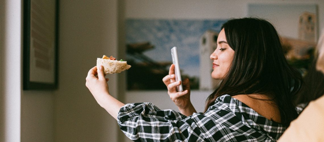 influencer taking photo of a food